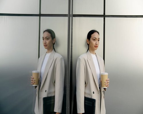 Office employee in downtown Jakarta taking a short standing break away from computer
