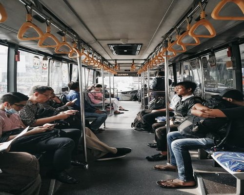 A modern urban bus public transport system where passengers maintain smart standing posture